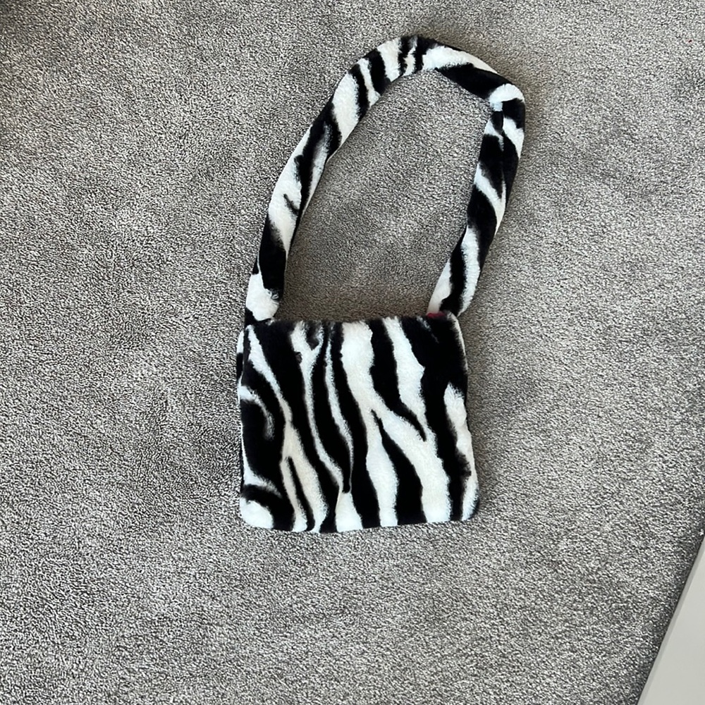 Zebra bag with a hot pink inside, bought from etsy a few years ago